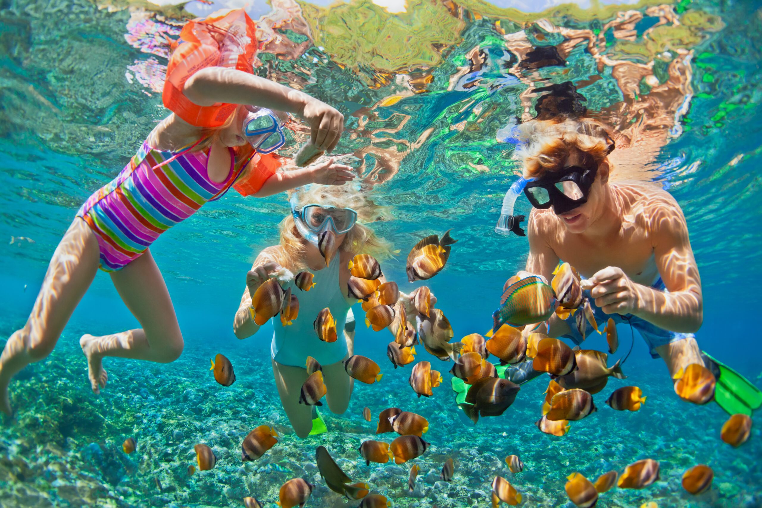 Happy family snorkeling in Bahamas